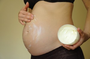 Pregnant-woman-applying-cream